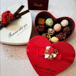 Luxury dark chocolates in brown gift box with gold ribbon