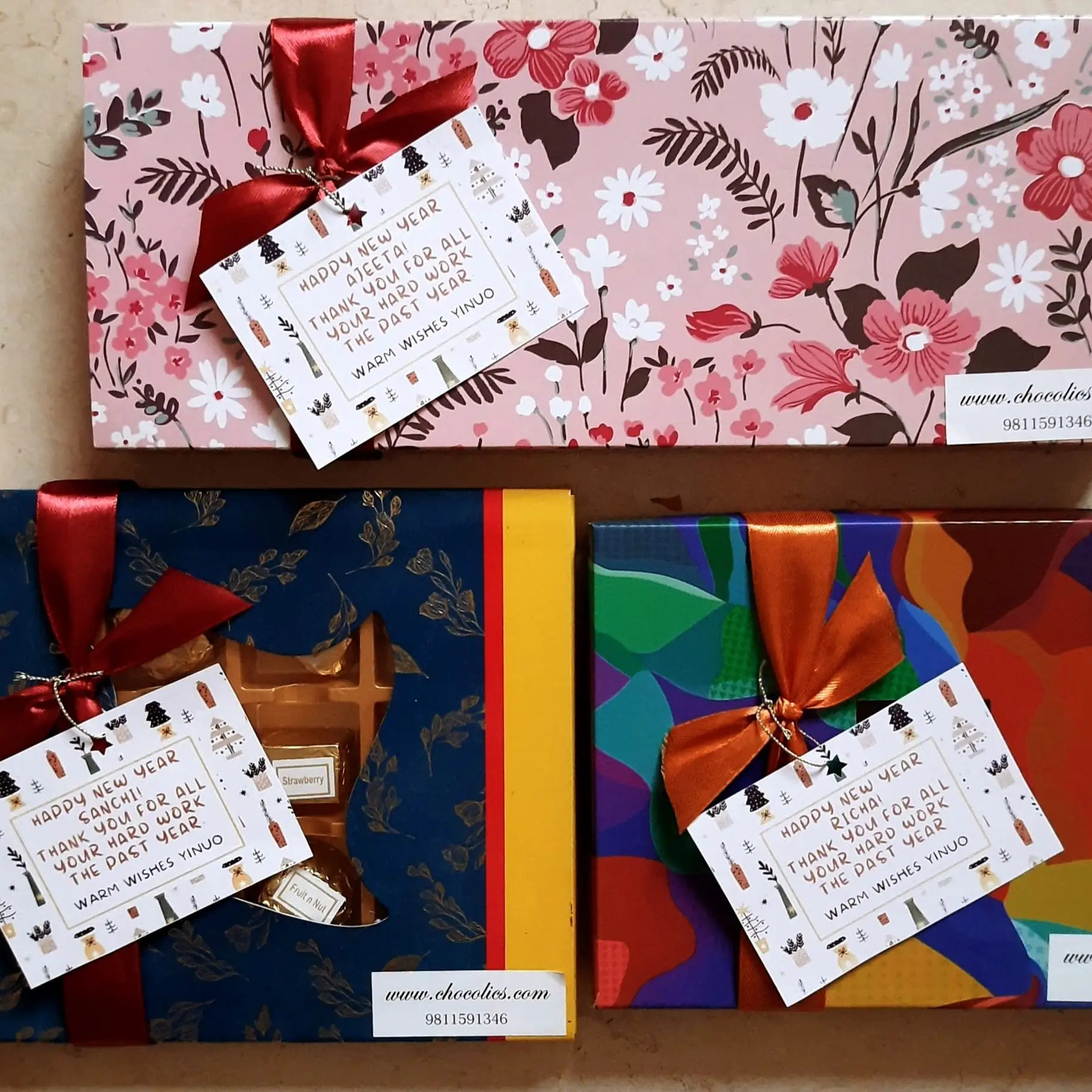 Chocolate gift boxes with personalised message cards in festive wrapping