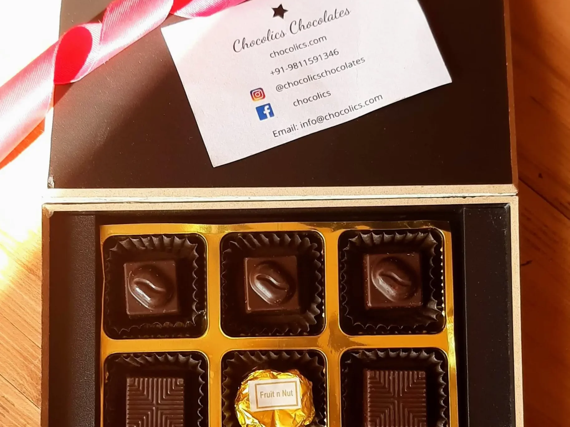 Corporate chocolate gift box with logo branding and gold wrap