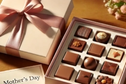 a box of chocolates with a bow and a card