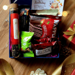 Luxury gift hamper with tea in test tube, chocolate waffles, cookies, premium chocolate bar, date bite, kaju coconut treat, personalised card and magnetic box with satin ribbon