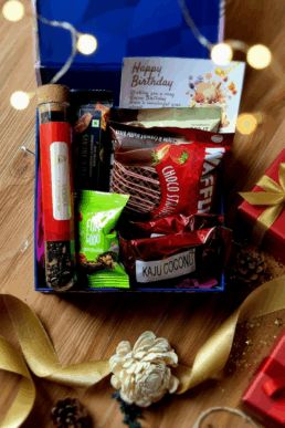 Luxury gift hamper with tea in test tube, chocolate waffles, cookies, premium chocolate bar, date bite, kaju coconut treat, personalised card and magnetic box with satin ribbon