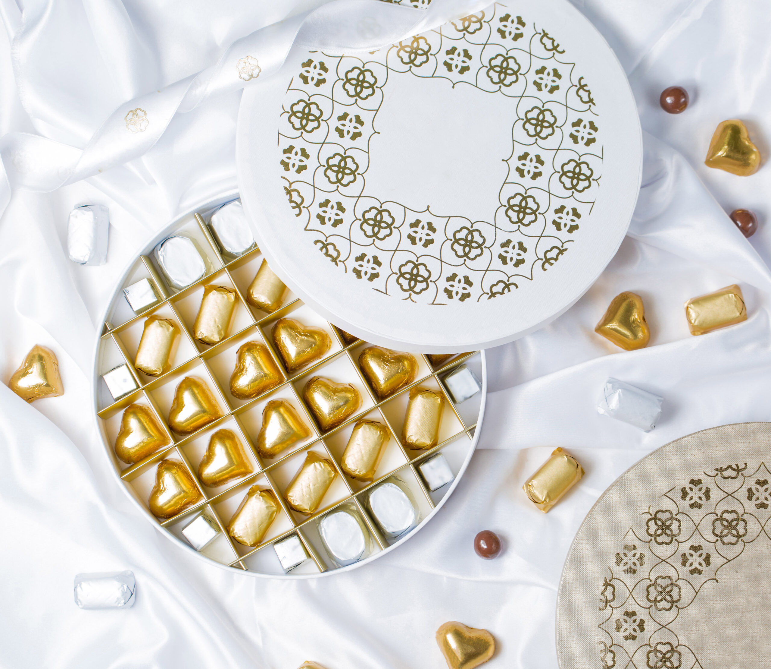 top view round chocolate box with golden silver wrapped chocolates scaled top view of round chocolate box with golden and silver wrapped chocolates